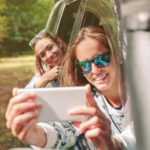 woman takes photo in car